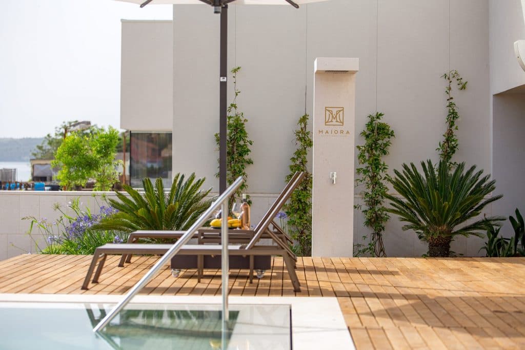 Custom limestone outdoor shower set in a landscape