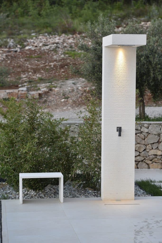 Finished custom limestone outdoor shower by Daydream