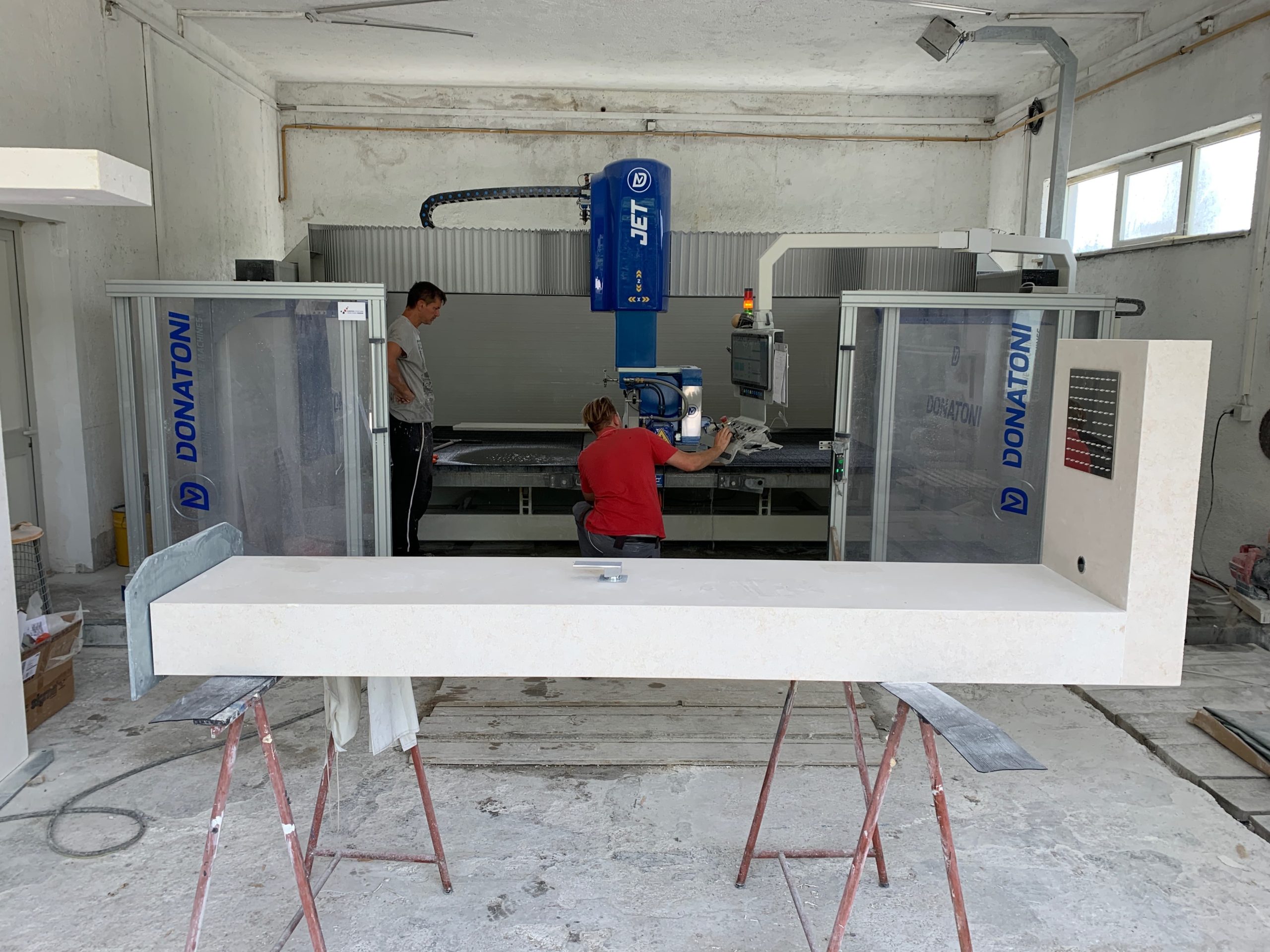 Limestone shower being fabricated by hand in the Daydream Stone Atelier