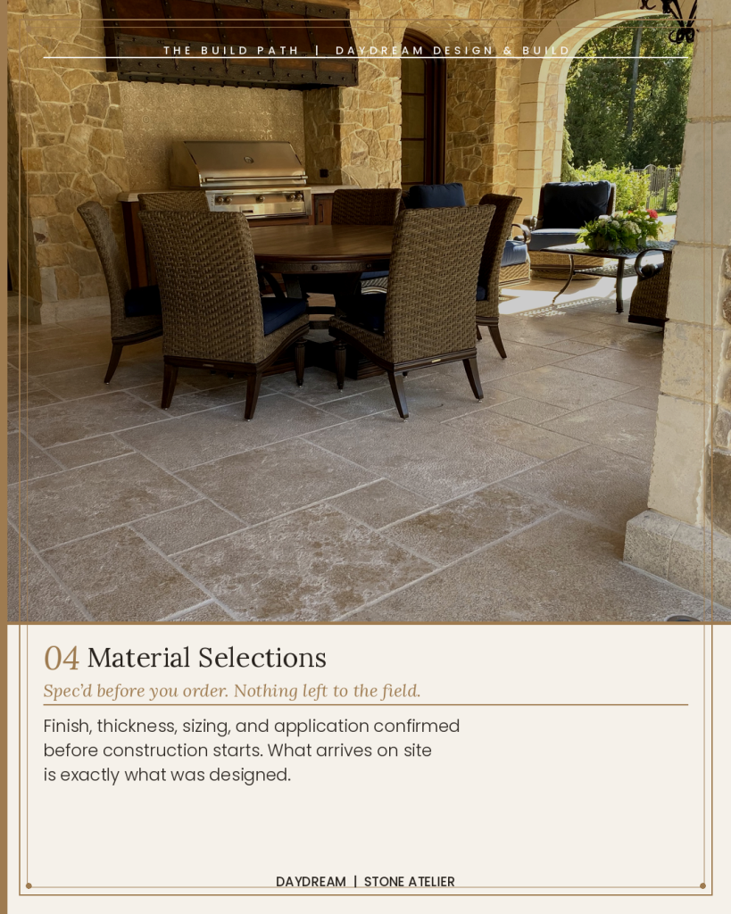 Covered outdoor kitchen and dining space with limestone floor paving natural stone walls arched columns and outdoor grill North Metro Atlanta Daydream Design Build