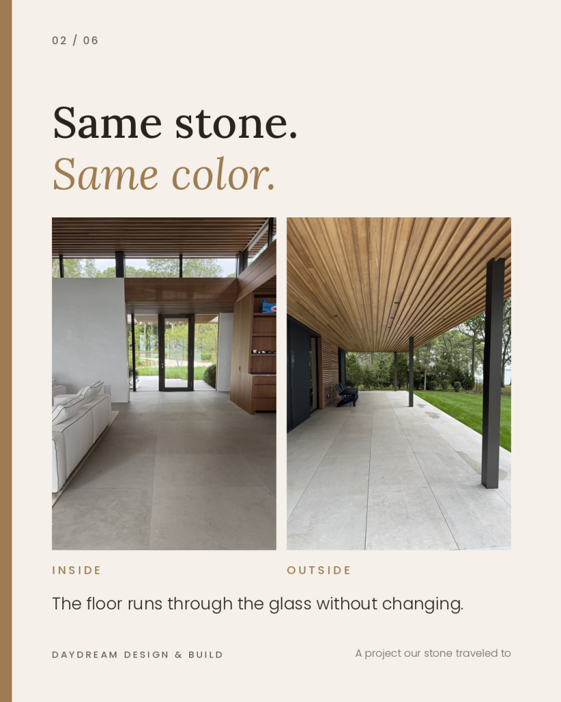 One Stone Inside and Out: Using the Same Natural Stone for Interior Floors and Outdoor Living 2 Living room with large-format grey natural stone floor tile leading to a glass front door, with a white sofa and wood cabinetry.